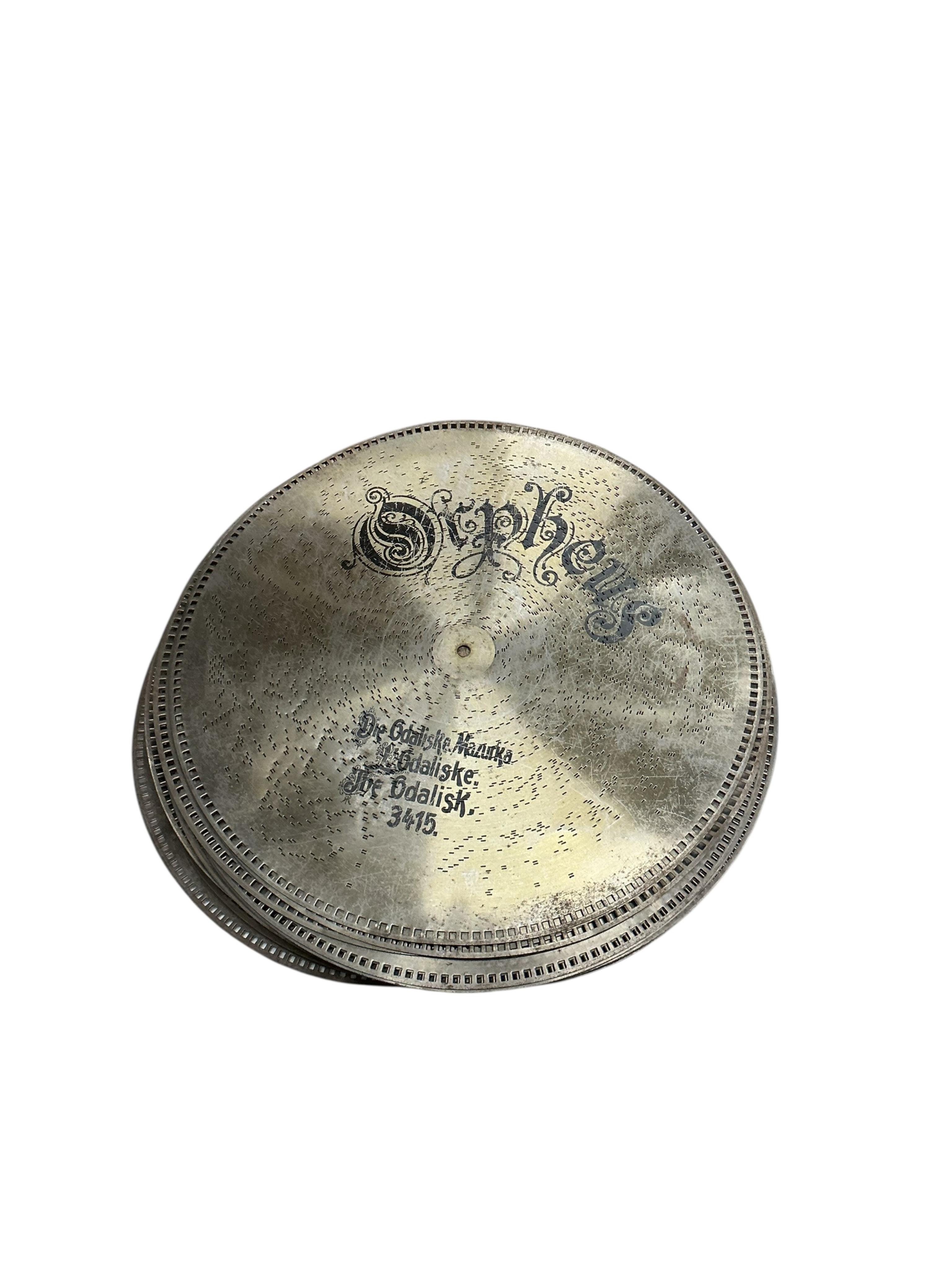 A substantial early 20th century inlaid walnut cased tabletop Orpheus polyphon on a floor standing base containing a compartment for storing the discs, together with thirty-seven 57.5cm diameter discs, and a winding hand